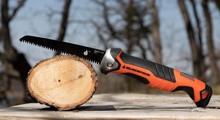 Blackfire Folding Saw Resting over 5 inch log that it cut